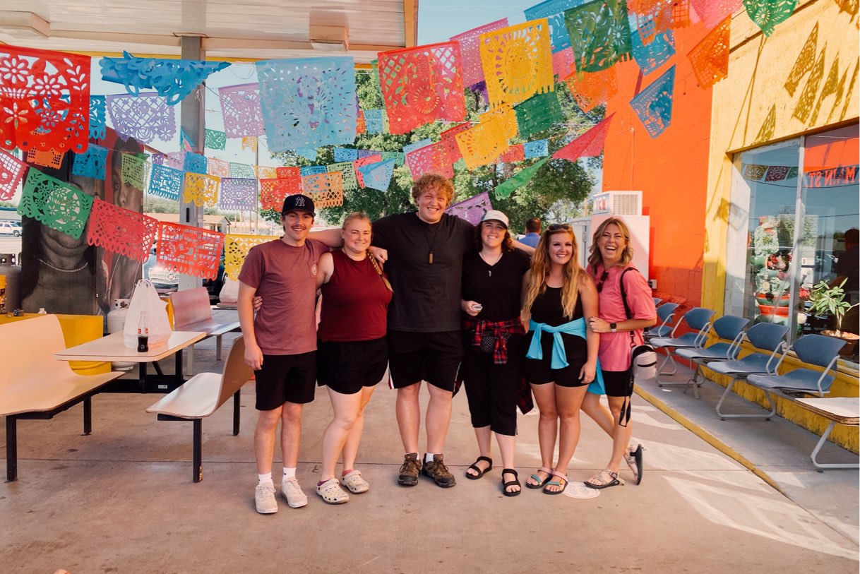 Group of people from New Haven under art flags, New Haven Residential Treatment Center