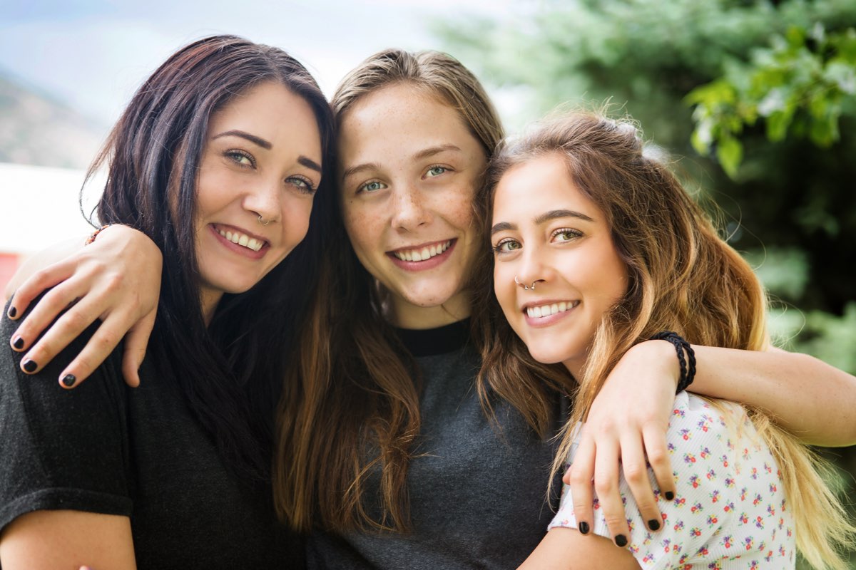 Family smiling, three girls at New Haven Smiling girls attending New Haven Residential Treatment Center