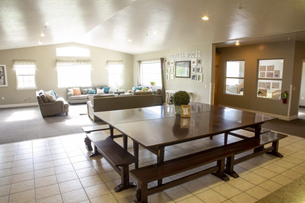 Kitchen table and living room, mother teresa house, new haven residential treatment center